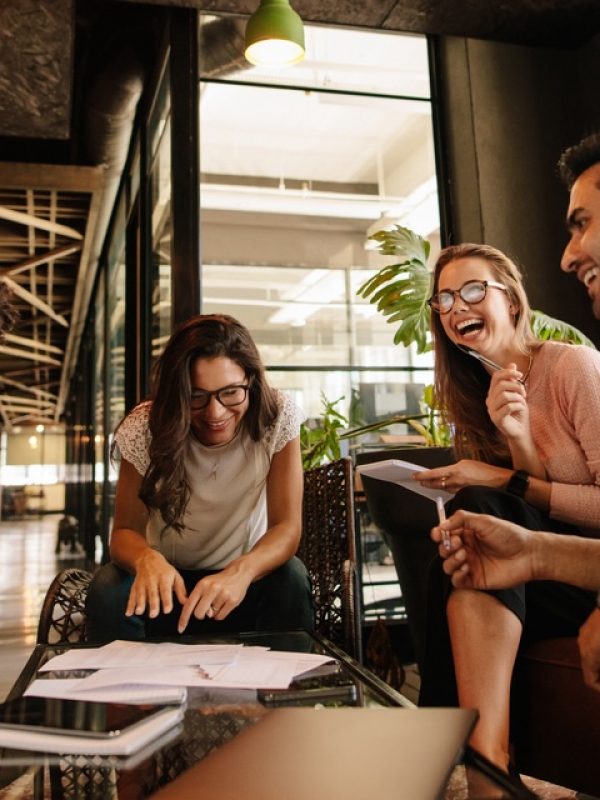 Team of corporate professionals having friendly discussion in a meeting. Multi ethnic business team having project discussion.